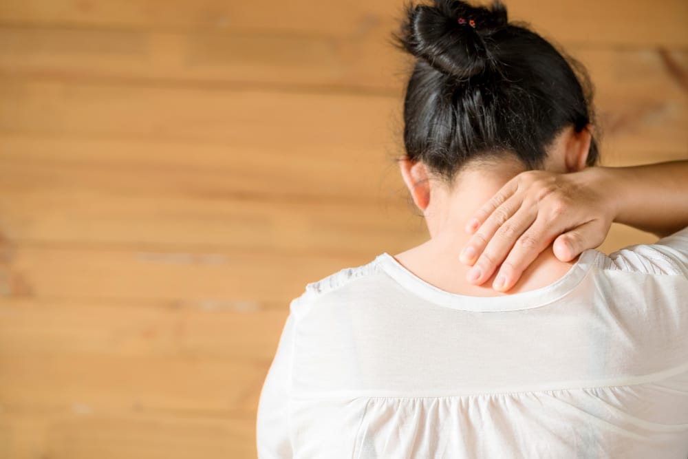 woman feeling exhausted suffering from neck pain