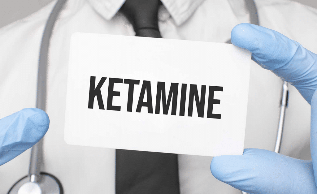 ketamine text on a card held by a doctor