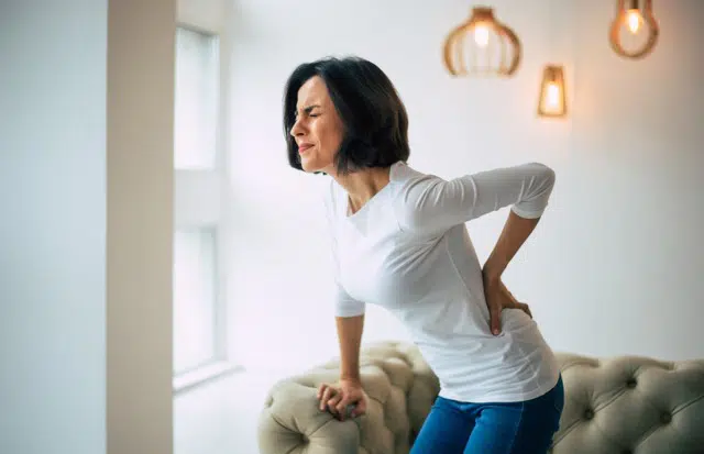 Woman suffering from severe chronic back pain