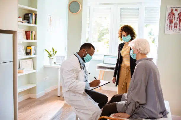 Close up of a senior woman and her daughter having a consultation from the doctor