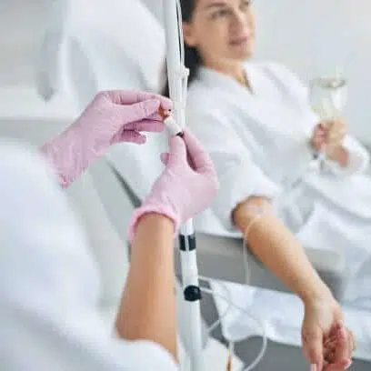 A physician giving a Energy Boost IV Therapy drip to the patient