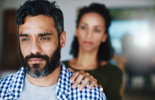  woman comforting her distraught husband at home