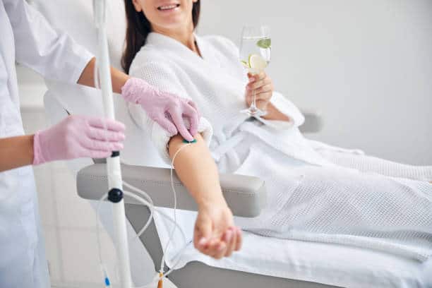 Woman is getting a IV therapy for beauty