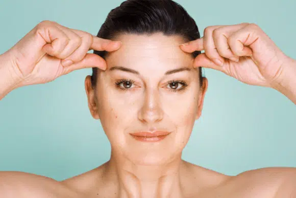 Woman having Fine Lines & Wrinkles in the forehead.