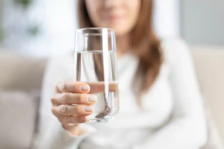 Woman having plenty of water after having a hair laser removal.