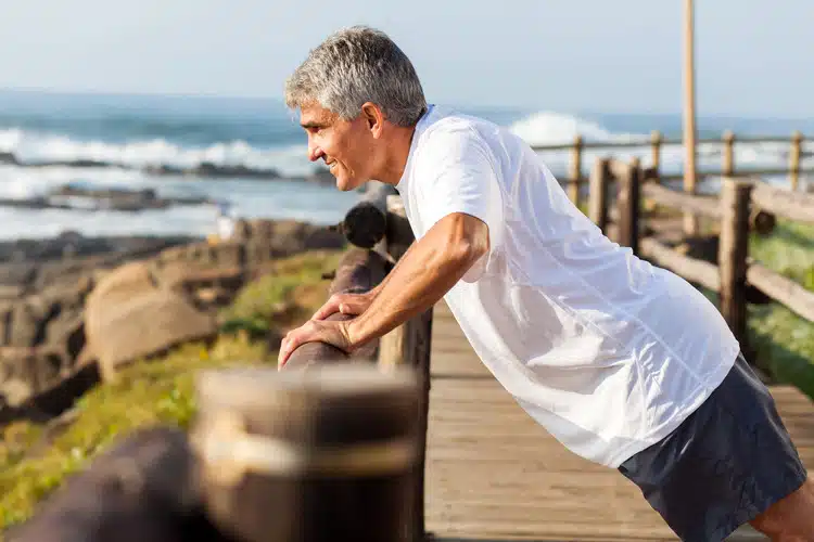 Old man doing some outdoor physical exercise.